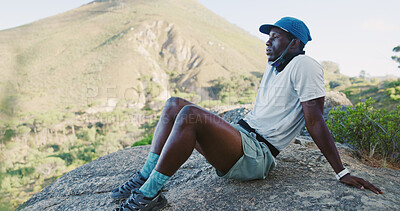 Buy stock photo Break, fitness and black man on mountain for hiking, exercise or health in nature for breathing. Fatigue, recovery and African person with rest for trekking outdoor with challenge and wellness.
