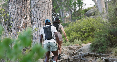 Buy stock photo Back, couple and hiking on mountain with fitness, adventure and exercise together for wellness goals. Active, interracial people and walk in forest with outdoor exploration, workout and trekking