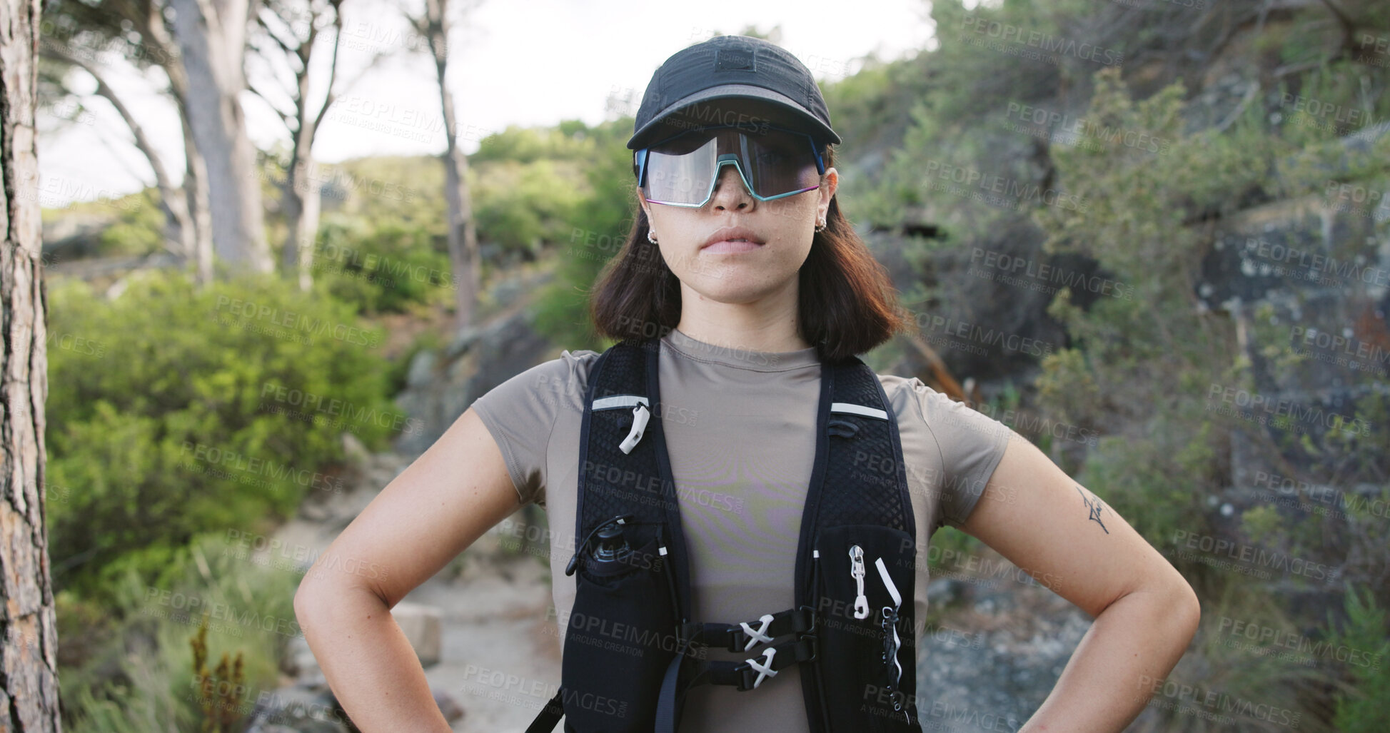 Buy stock photo Outdoor, hiking and woman with glasses in woods, traveler and travel with hydration vest on vacation. Serious, hiker and person on holiday in nature, portrait and confident for exploration in Canada