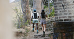 Back, couple and hiking in woods with fitness, adventure and exercise together for wellness goals. Active, people and walk on mountain with outdoor exploration, workout and interracial relationship.