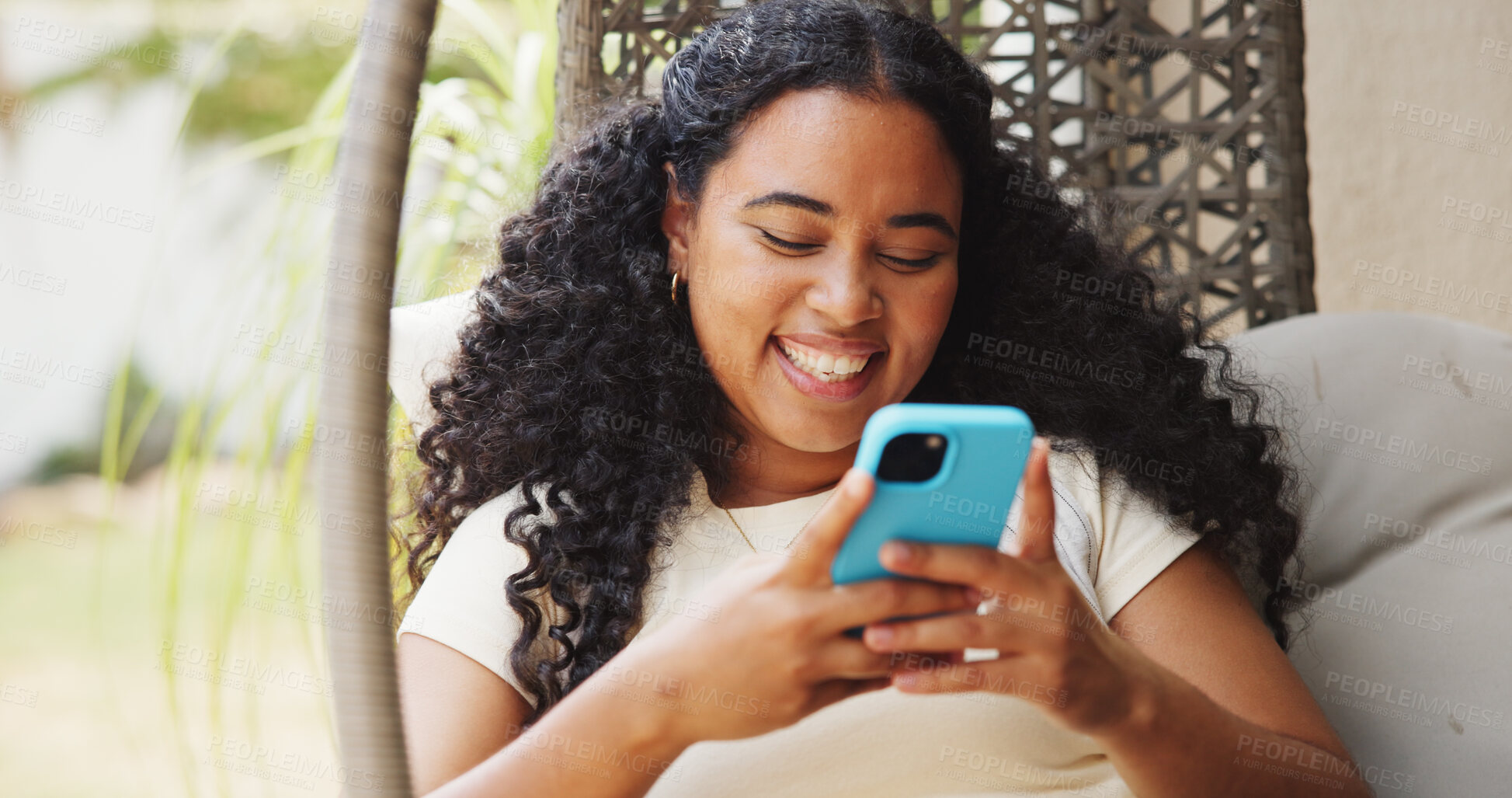 Buy stock photo Patio, online and happy woman with phone for chat, communication and reading message on social media. Person, smile and texting with mobile on swing, home and networking with contact on website