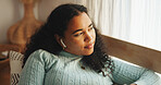Woman, thinking and relax with earphones in home, listening to podcast or reflection with smile. Person, calm or peace with audio tech for radio, music or audiobook entertainment with break at house