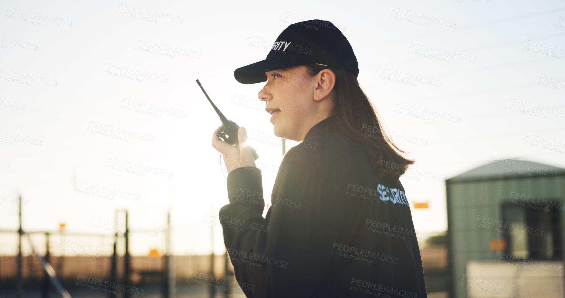 Buy stock photo Conversation, security and woman outdoor with radio for communication, sunset surveillance and guard. Protection, service and person with tech for safety, perimeter search or patrol in property space