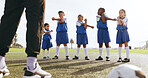Coach, kids and stretching on field for soccer, practice and help getting ready for sport game. Trainer, legs and children training for football match with warm up, exercise and athlete group outdoor