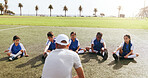 Field, children or man with coaching for soccer, sports training or warm up instructions for practice. Fitness, football or coach with kids team for stretching exercise, outdoor or match preparation