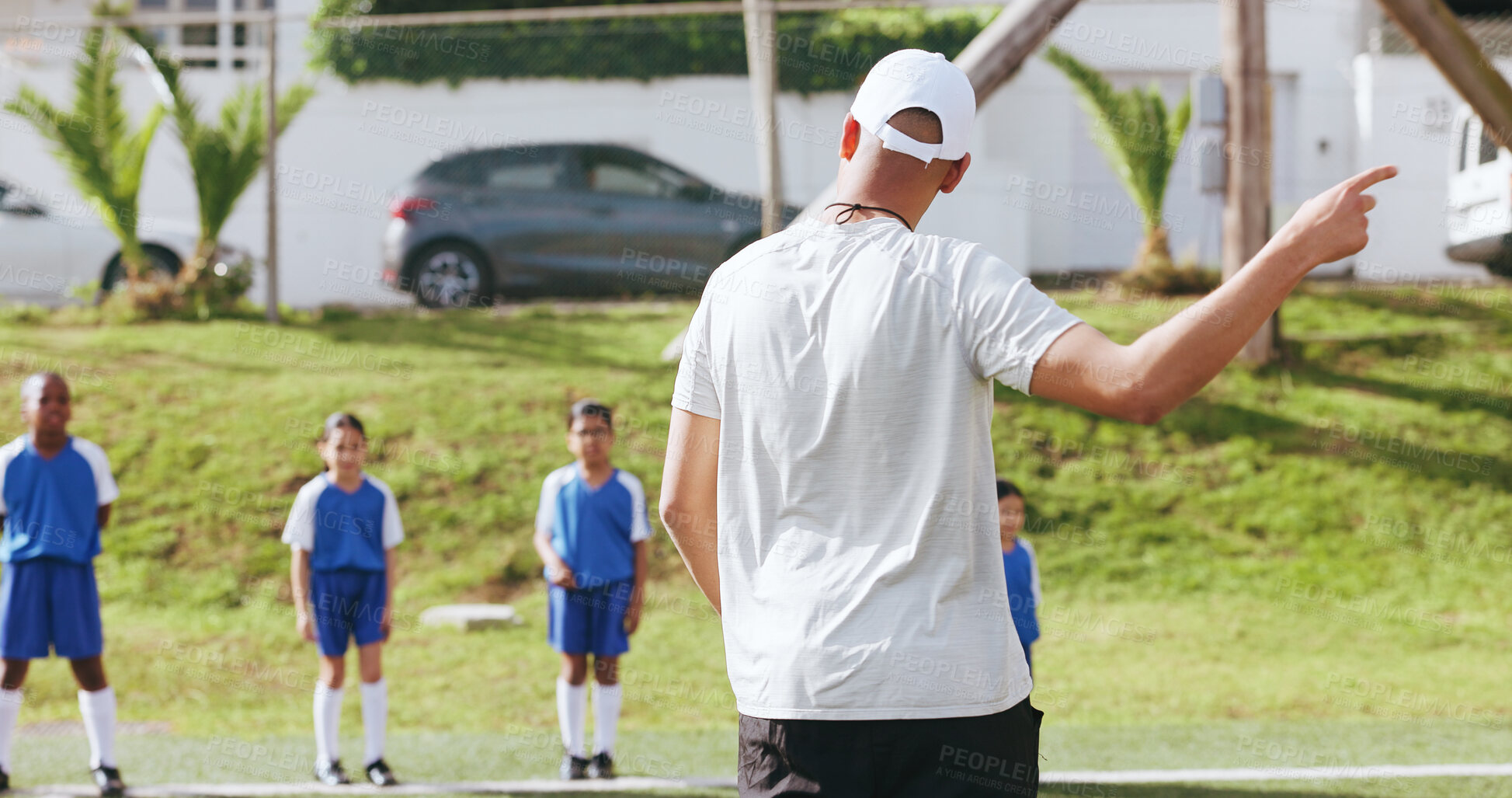 Buy stock photo Coach, team and kids on field for sports, practice and help with football game play. Man, children and soccer match, training and exercise with youth athlete group at pitch for fitness outdoor