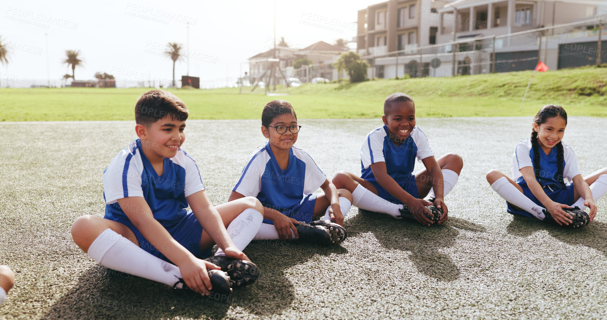 Buy stock photo Happy, children or soccer team on field with stretching, warm up or friendly match on weekend break. Fitness, smile or kids with preparation, football competition or injury prevention in sports hobby
