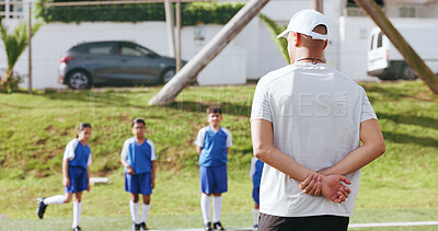 Buy stock photo Outdoor, children or man with coaching for football, sports training or instructions for practice match. Fitness, soccer club or coach with kids team for skill development, field or explain exercise