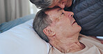Sad, sick and senior couple on bed in home for bonding, support or comfort in medical recovery. Rest, love and elderly woman hugging man in bedroom for care, marriage and retirement in house.