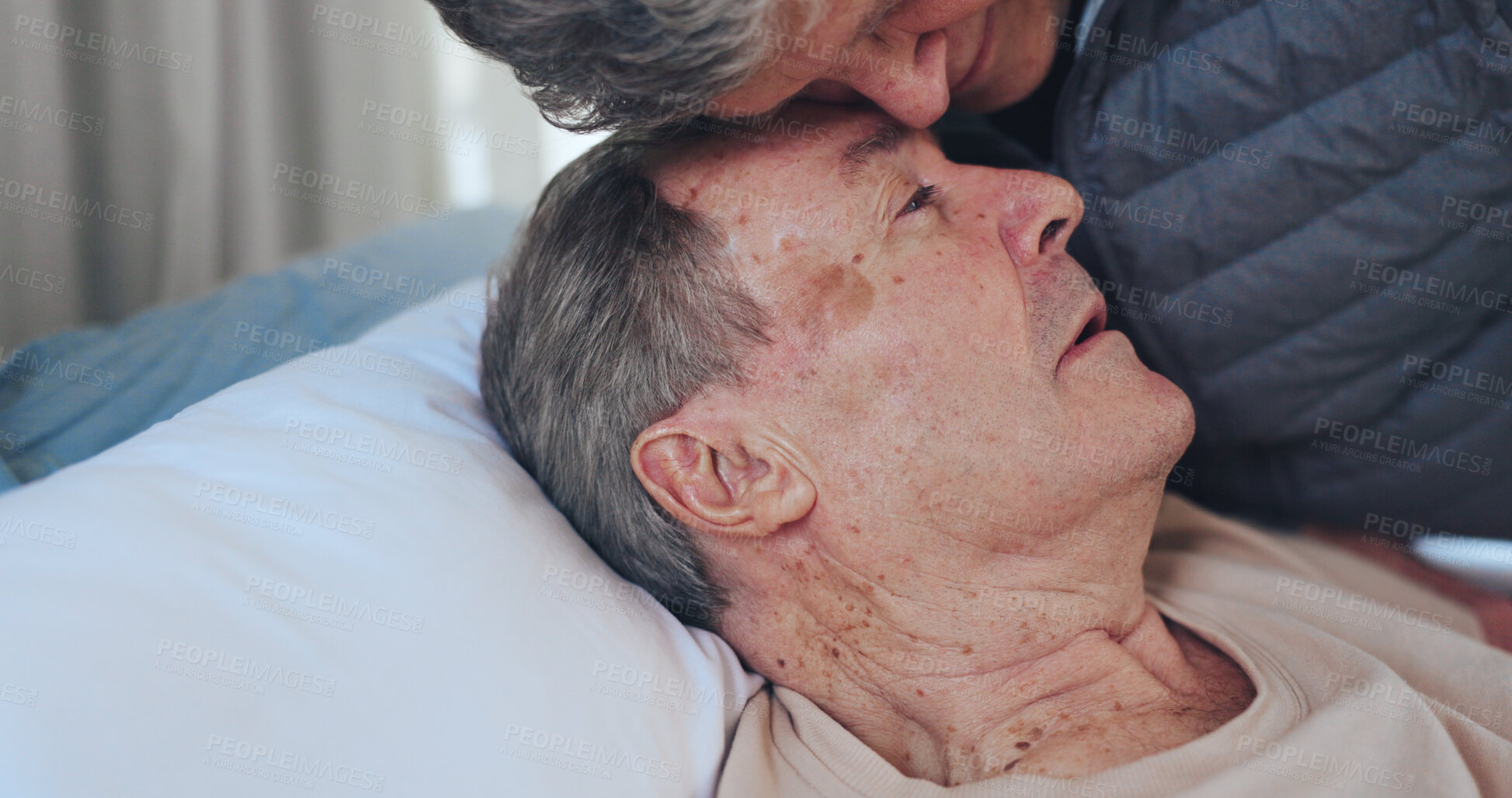 Buy stock photo Sad, sick and senior couple on bed in home for bonding, support or comfort in medical recovery. Rest, love and elderly woman hugging man in bedroom for care, marriage and retirement in house.