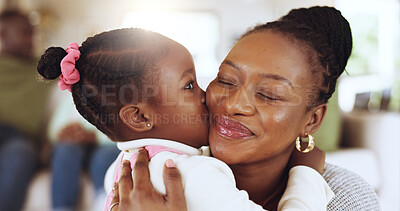 Buy stock photo Kiss, love and mom with daughter in family home for bonding, support and mothers day. Happiness, trust and hug with black woman and child in living room of apartment for thank you and connection