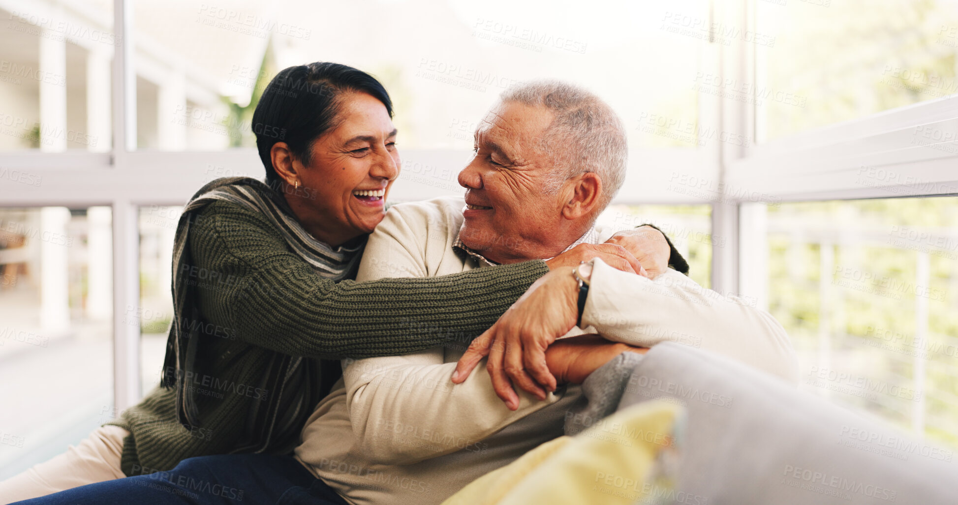 Buy stock photo Happy, hug and senior couple on sofa in home with love, care and marriage together on weekend. Smile, relax and elderly woman embracing man in living room for relationship, connection or bonding.