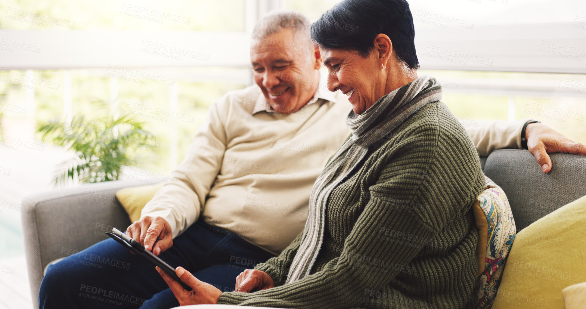 Buy stock photo Happy, tablet and senior couple on sofa in home with watching film show or series together. Smile, relax and elderly woman with man in living room for bonding with streaming movie on app in house.