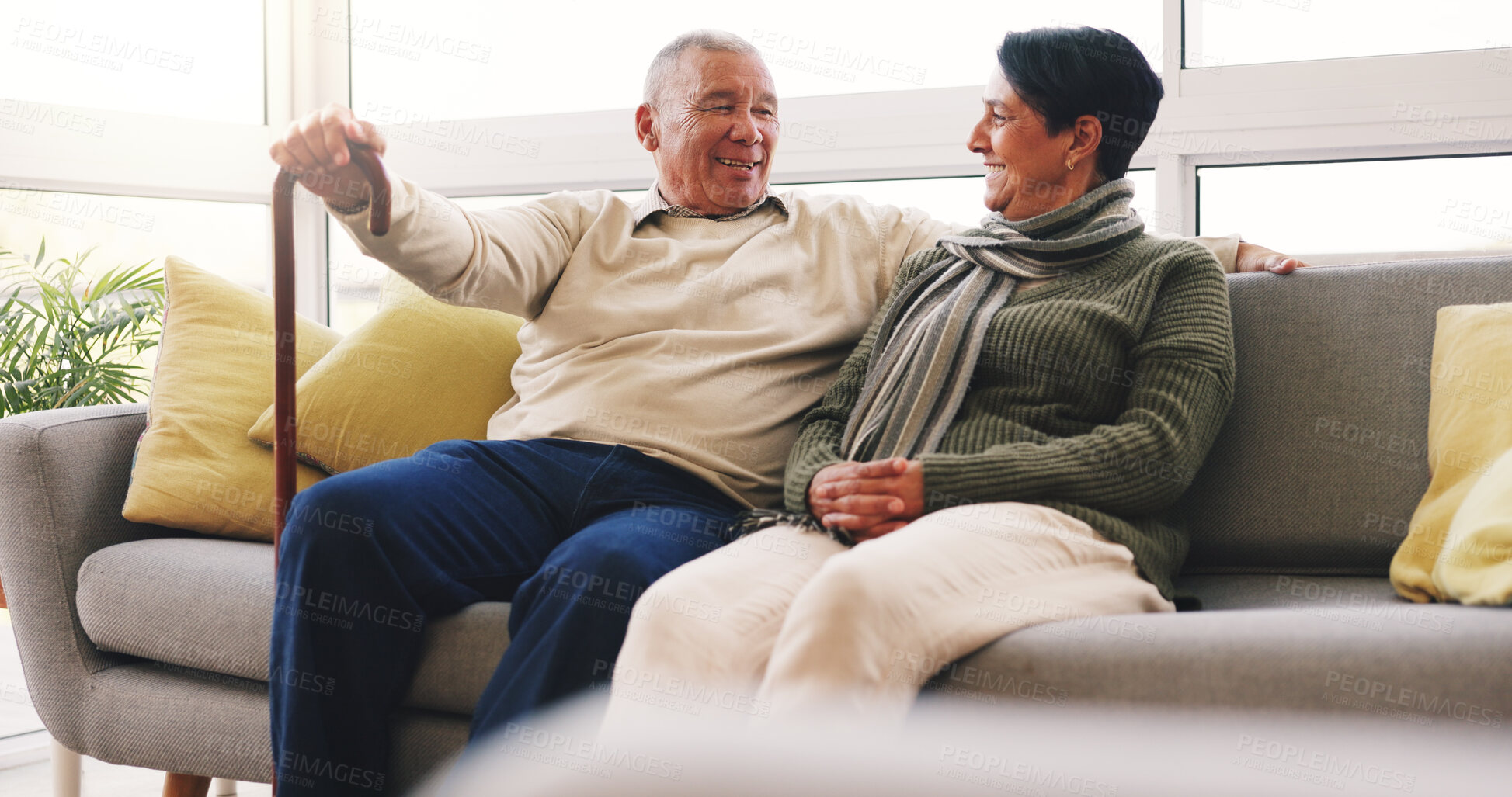 Buy stock photo Happy, conversation and senior couple on sofa in home with love, care and marriage together on weekend. Smile, relax and elderly woman with man in living room for relationship, connection or bonding.