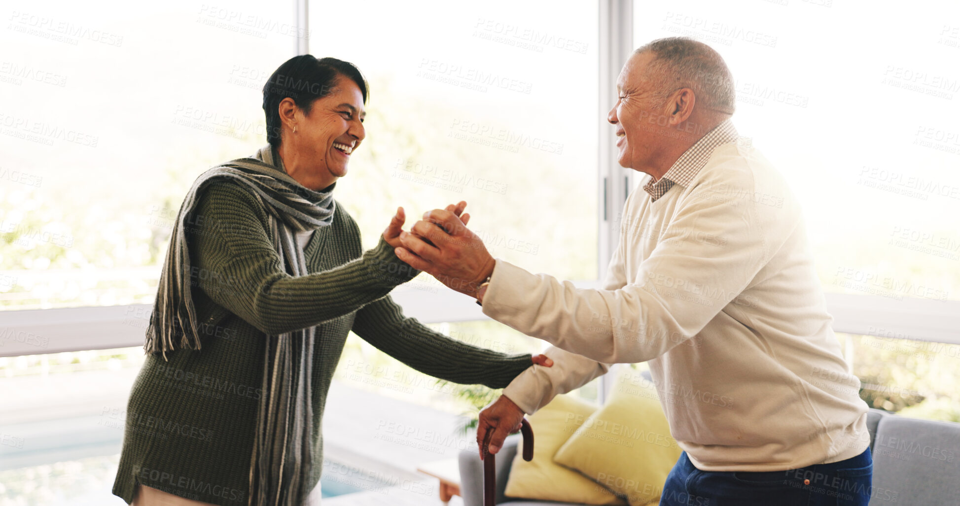 Buy stock photo Dance, love and cane with old couple in home for anniversary, bonding and help. Marriage celebration, walking stick and holding hands with senior man and woman in living room of apartment for support