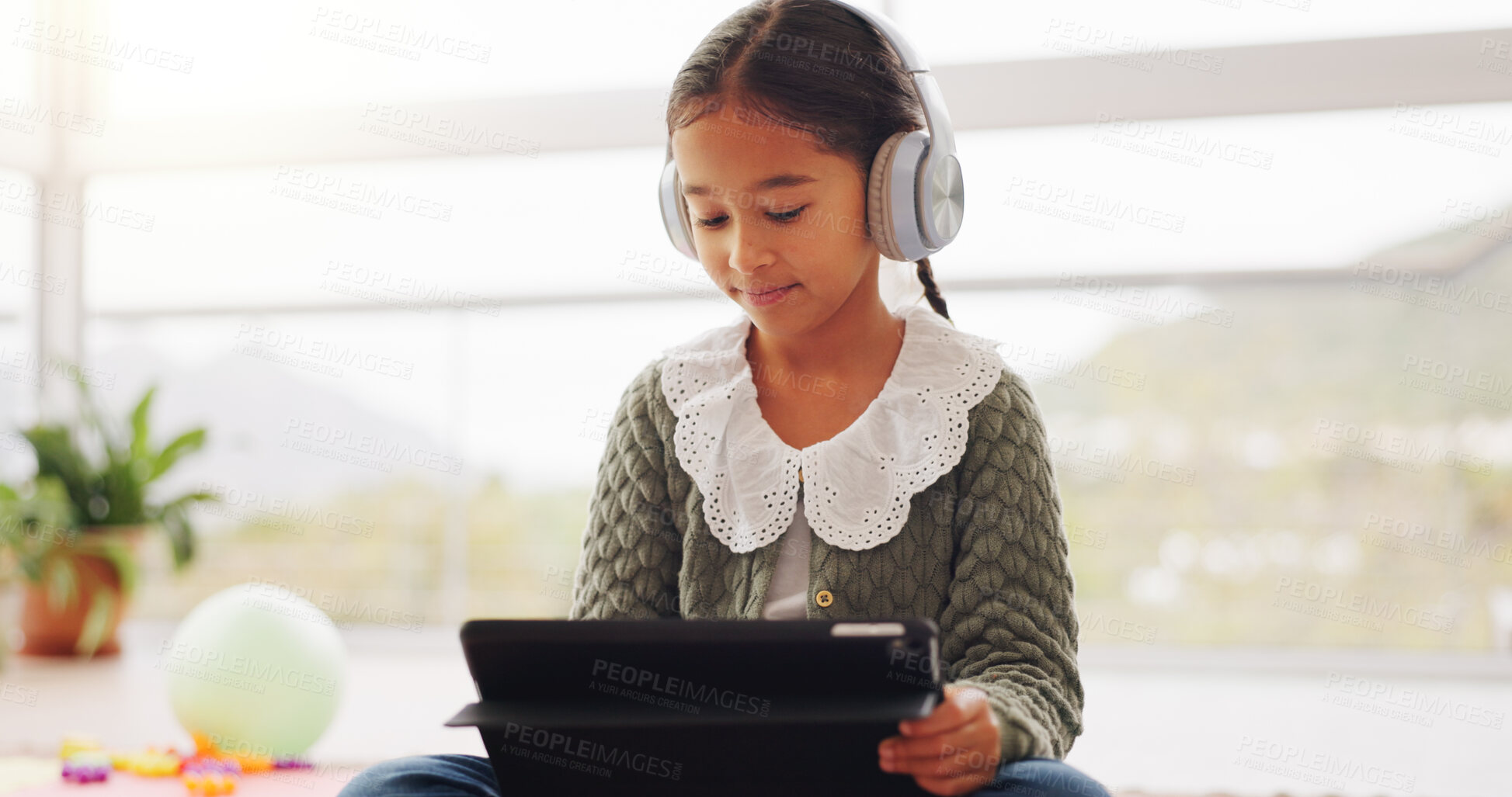 Buy stock photo Headphones, tablet and learning with child in home for math assessment, studying or digital lesson. Online course, education app and student project with girl in house for research and growth
