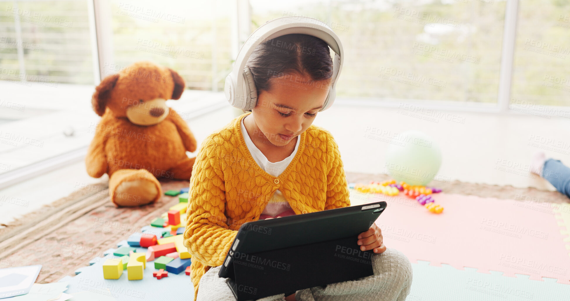Buy stock photo Headphones, tablet and studying with child in home for math games, learning or digital lesson. Online subscription, education app and development website with girl in house, growth or audio guide