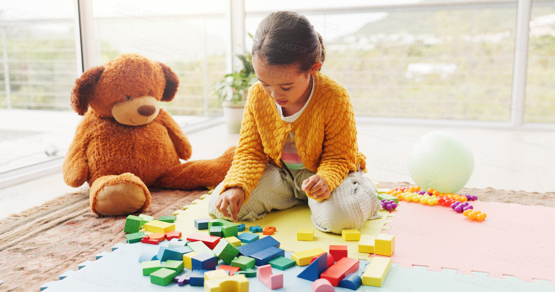 Buy stock photo Toys, playing and child on floor with building blocks for learning, development and creative skills. Home, morning and girl with color, shapes and teddy bear for growth, education and puzzle in house