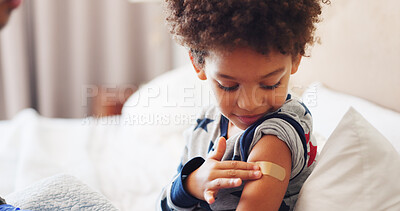 Buy stock photo Healthcare, smile and child with plaster in home, wellness or skin protection after flu vaccination. Happy, boy and recovery from illness on bed, help and infection prevention with bandage in house