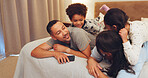 Happy, relax and parents with children on bed for love, bonding and talking together at night. Family, home and mom, dad and kids in bedroom for loving relationship, smile and connection on weekend