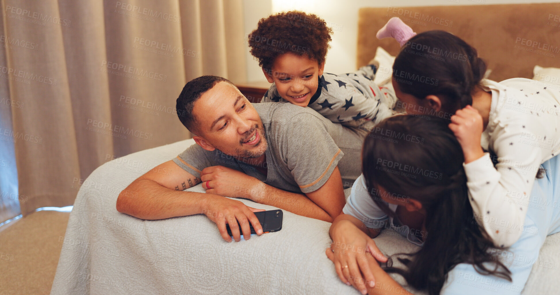 Buy stock photo Happy, relax and parents with children on bed for love, bonding and talking together at night. Family, home and mom, dad and kids in bedroom for loving relationship, smile and connection on weekend