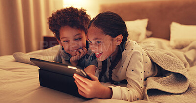 Buy stock photo Tablet, relax and kids on bed in home at night with watching movie, film or series on app on weekend together. Happy, digital technology and children streaming show online in bedroom at house.