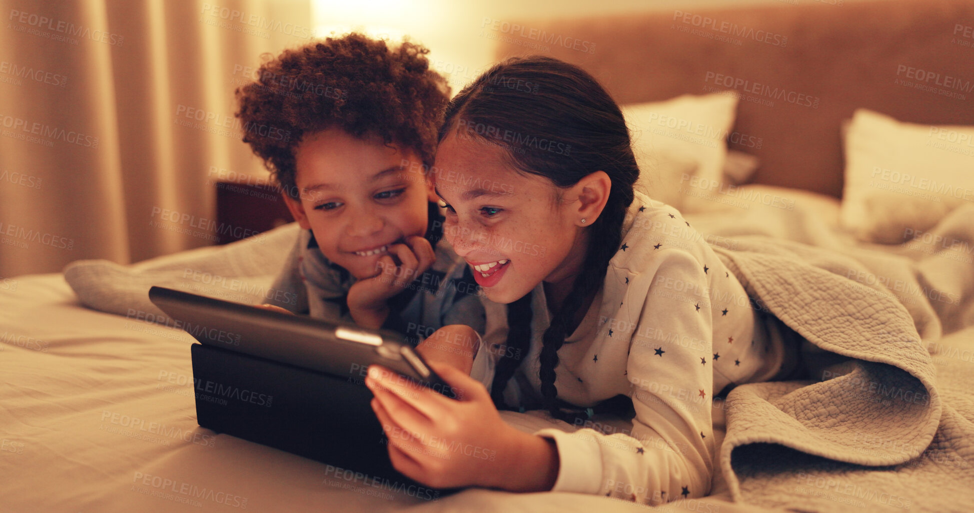 Buy stock photo Tablet, relax and kids on bed in home at night with watching movie, film or series on app on weekend together. Happy, digital technology and children streaming show online in bedroom at house.