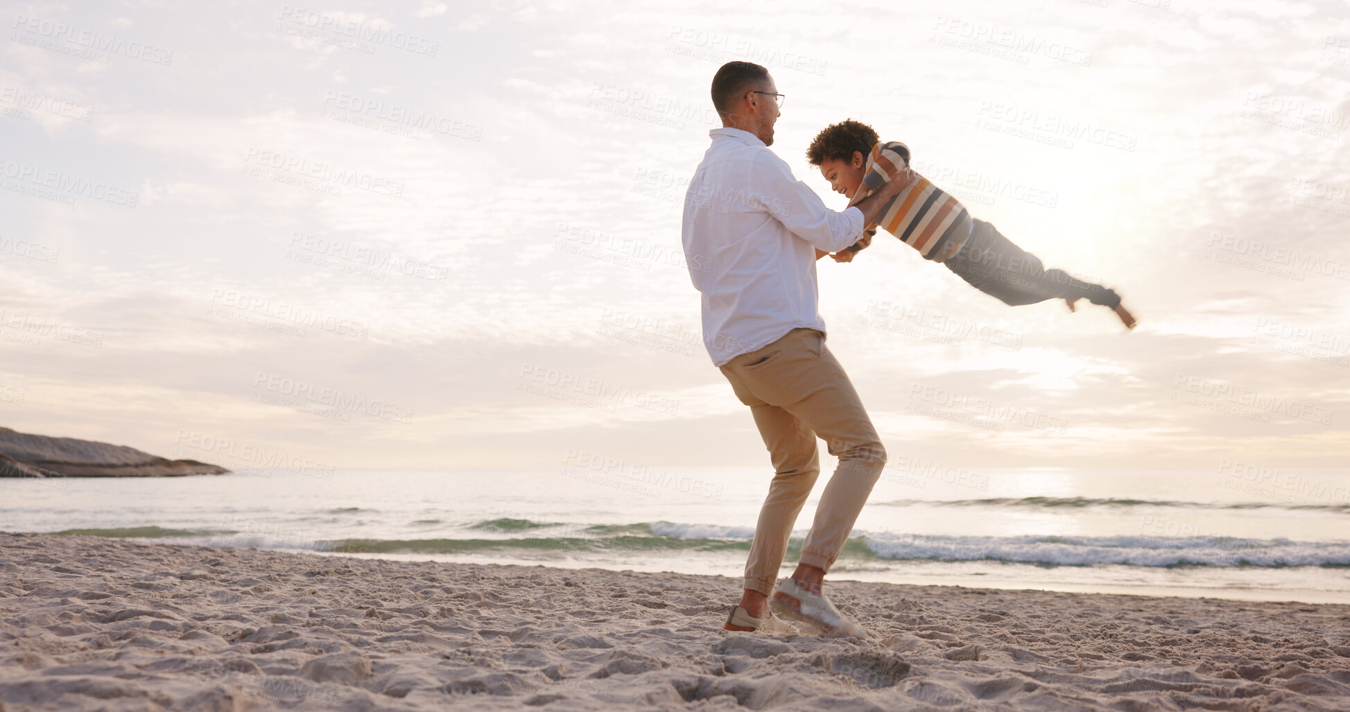 Buy stock photo Happy, spin and dad with child at beach for bonding, love and connection on summer holiday. Family, space and father with boy for playing, games and fun by ocean for relationship, relax and vacation