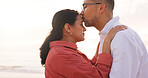 Happy, beach and couple with forehead kiss for holiday, vacation and affection outdoor on weekend. Love, marriage and man with woman by ocean, sea and nature for bonding, relationship and romance