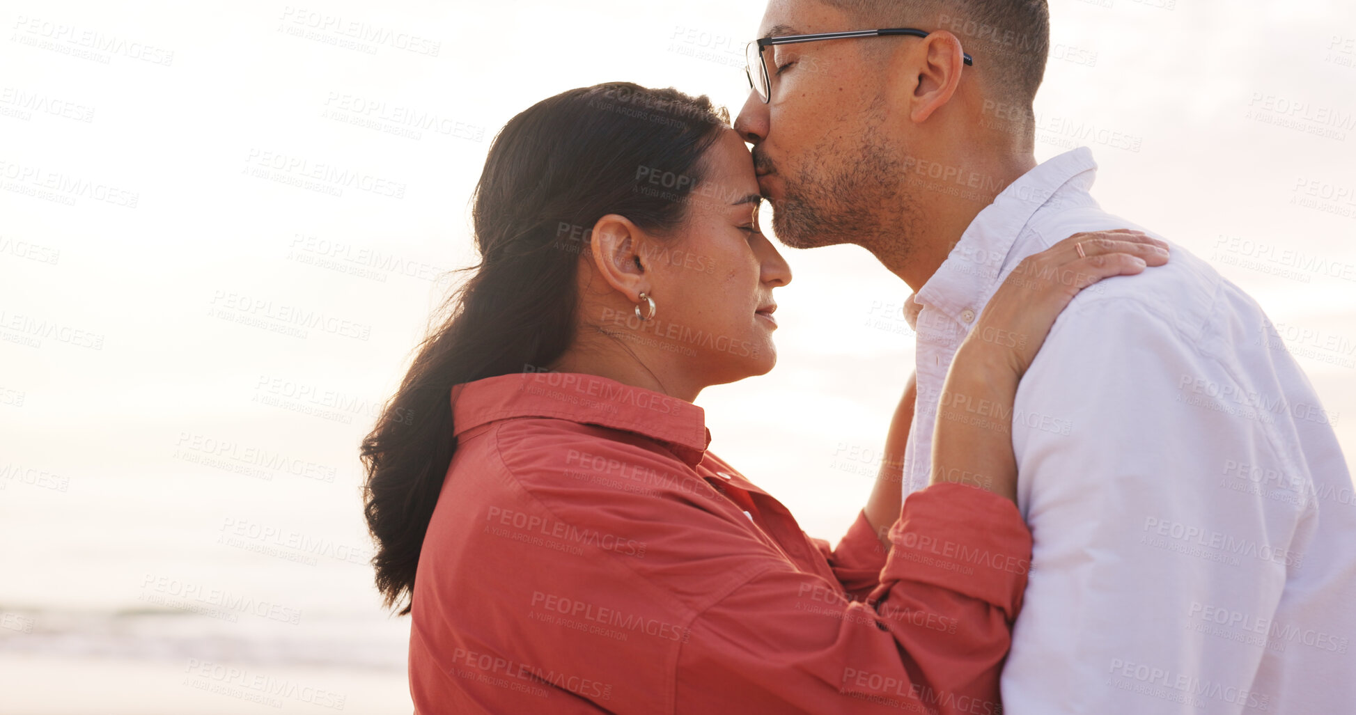 Buy stock photo Happy, beach and couple with forehead kiss for holiday, vacation and affection outdoor on weekend. Love, marriage and man with woman by ocean, sea and nature for bonding, relationship and romance