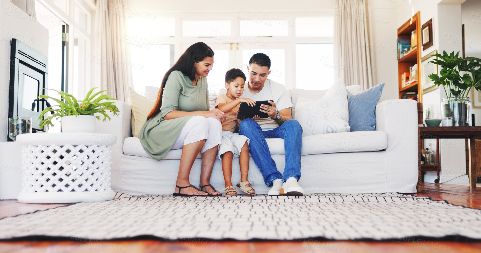 Buy stock photo Parents, elearning and child with tablet in lounge, development or watching educational video on app. Home, happy people and family with tech for knowledge, growth and bonding with kid on weekend