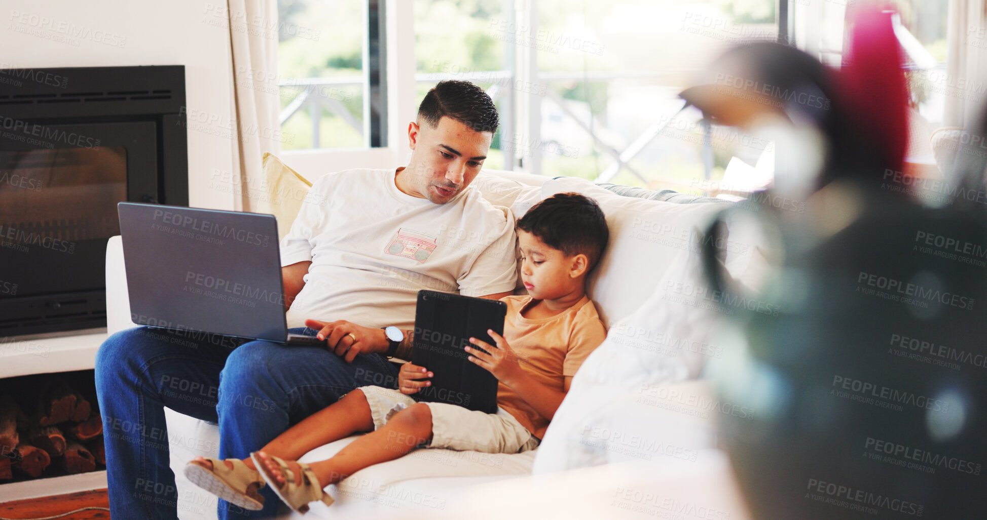 Buy stock photo Laptop, tablet and dad with child on sofa for internet, online streaming and connection on weekend. Family, home and father with boy on digital tech for website, watching videos and bonding together