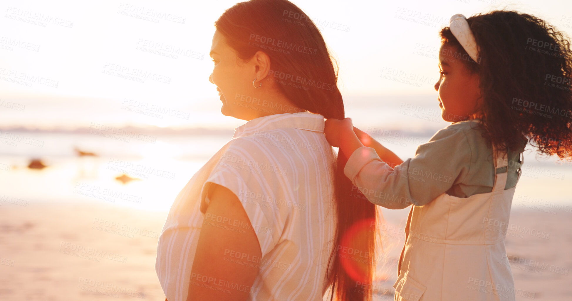 Buy stock photo Playing, hair and mom with child at beach for bonding on vacation, holiday and summer morning. Sunrise, travel and girl with hairstyle for mother by sea for relationship, connection and love outdoor