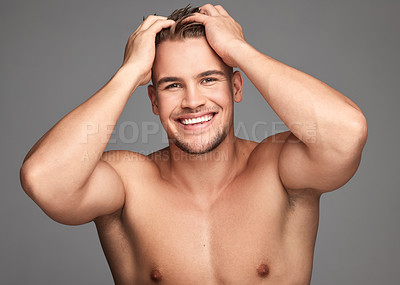 Buy stock photo Hair, portrait and smile of man in studio for satisfaction with cosmetics or dermatology results. Haircare, happy and touch with masculine person on gray background for shampoo benefits or wellness
