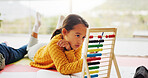 Counting, toys and child in home with abacus for learning, educational game and development for math. House, notebook and girl with beads for numbers, studying and creative activity on floor