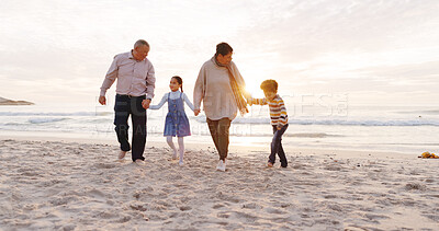Buy stock photo Happy, walking and grandparents with kids at beach for bonding, love and connection on holiday. Family, holding hands and children with grandma and grandpa for relationship, relax and travel by sea