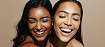 Happy women, laughing and beauty with makeup for multiracial skin tone on a studio background. Interracial friends, female people or smile with glow up, shine or texture for cosmetics together