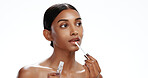 Thinking, woman and skincare with lipgloss in studio for beauty, plumping effect and hydration. Space, female person and vision with cosmetics, collagen product and lips treatment on white background