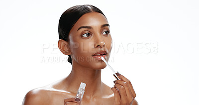 Buy stock photo Thinking, woman and skincare with lipgloss in studio for beauty, plumping effect and hydration. Space, female person and vision with cosmetics, collagen product and lips treatment on white background