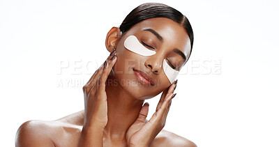 Buy stock photo Woman, relax and eye mask in studio with skincare, hyaluronic acid and reduction of dark circles. Calm person, collagen patch and product for beauty, hydration benefits and space on white background.