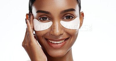 Buy stock photo Portrait, woman and eye mask in studio for beauty, skincare benefits and reduction of dark circles. Happy, female person and collagen patch for self care, dermatology and space on white background.