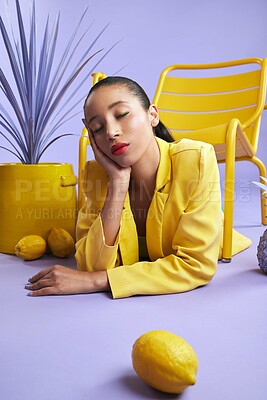 Buy stock photo Woman, fashion and color with lemon in studio for trendy style, art and edgy or yellow aesthetic. Purple background, bright and creative trend or makeup cosmetics with eyes closed and vibrant outfit