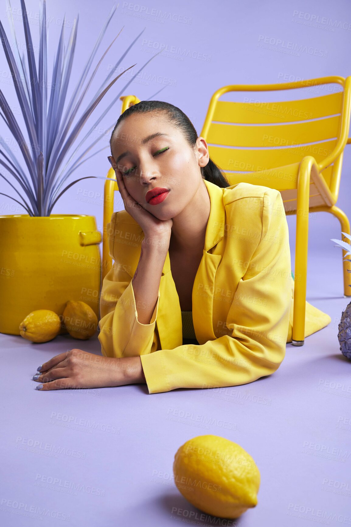 Buy stock photo Woman, fashion and color with lemon in studio for trendy style, art and edgy or yellow aesthetic. Purple background, bright and creative trend or makeup cosmetics with eyes closed and vibrant outfit