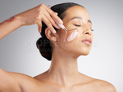 Buy stock photo Skincare, massage or woman with roller, sculpt or jaw contour in facial routine. Wellness, facelift or person with crystal tool, lymphatic drainage or irritation reduction on studio background.