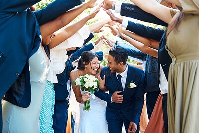 Buy stock photo Wedding, tunnel and couple ceremony for celebration walkway, symbolic passage and tradition. Smile, bride and groom with people for arch formation, newlywed send off and special occasion for marriage