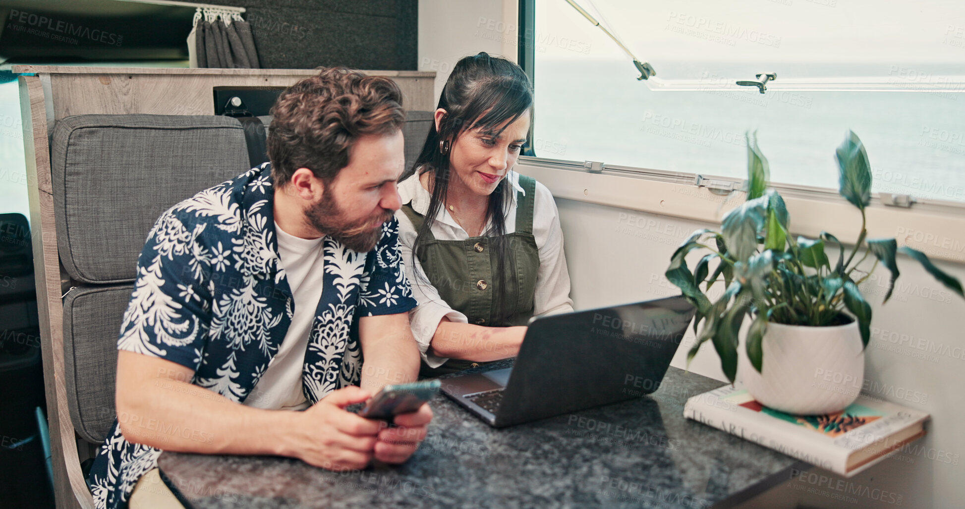 Buy stock photo Laptop, phone or couple in caravan for vacation, navigation website or roadside attraction research. Travel holiday, road trip or people with tech for campground availability, route planning or smile