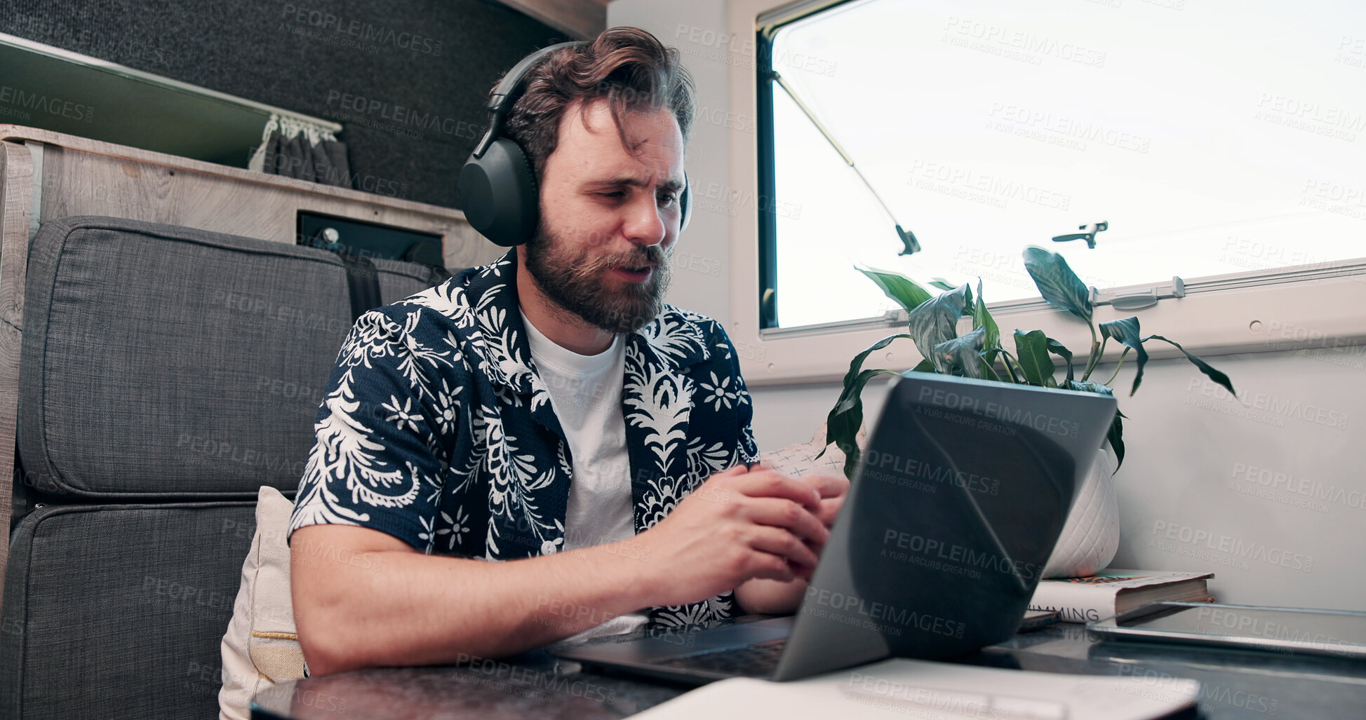 Buy stock photo Video call, laptop and woman with headphones in camper van for tourist guide, copywriting and notes. Freelancer, vehicle and person on computer for submission, travel blog or meeting for nomad living
