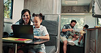Happy, mom and child on laptop in camper van for nomad living, travel and bonding in mobile home. Family, vehicle and mother with girl on computer for online videos, movies and relax on vacation