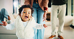 Parents, walking or baby with portrait in house, child development or excited for motor skills practice. Family, infant or happy girl with learning balance in lounge, first steps or milestone support