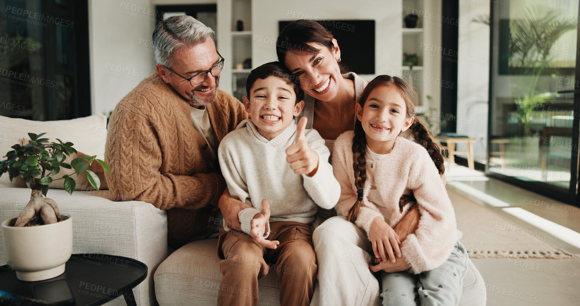 Buy stock photo Thumbs up, parents or children with hug in living room, happiness or support for relationship security. Portrait, people and kids with yes gesture for connection, family home and embrace for bonding